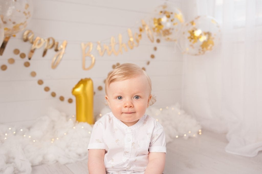 First Birthday, Gold, palm tree shirt, white shirt, clouds, twinkle, ginger ray garland, blonde haired boy, blue eyes, confetti balloons, kent