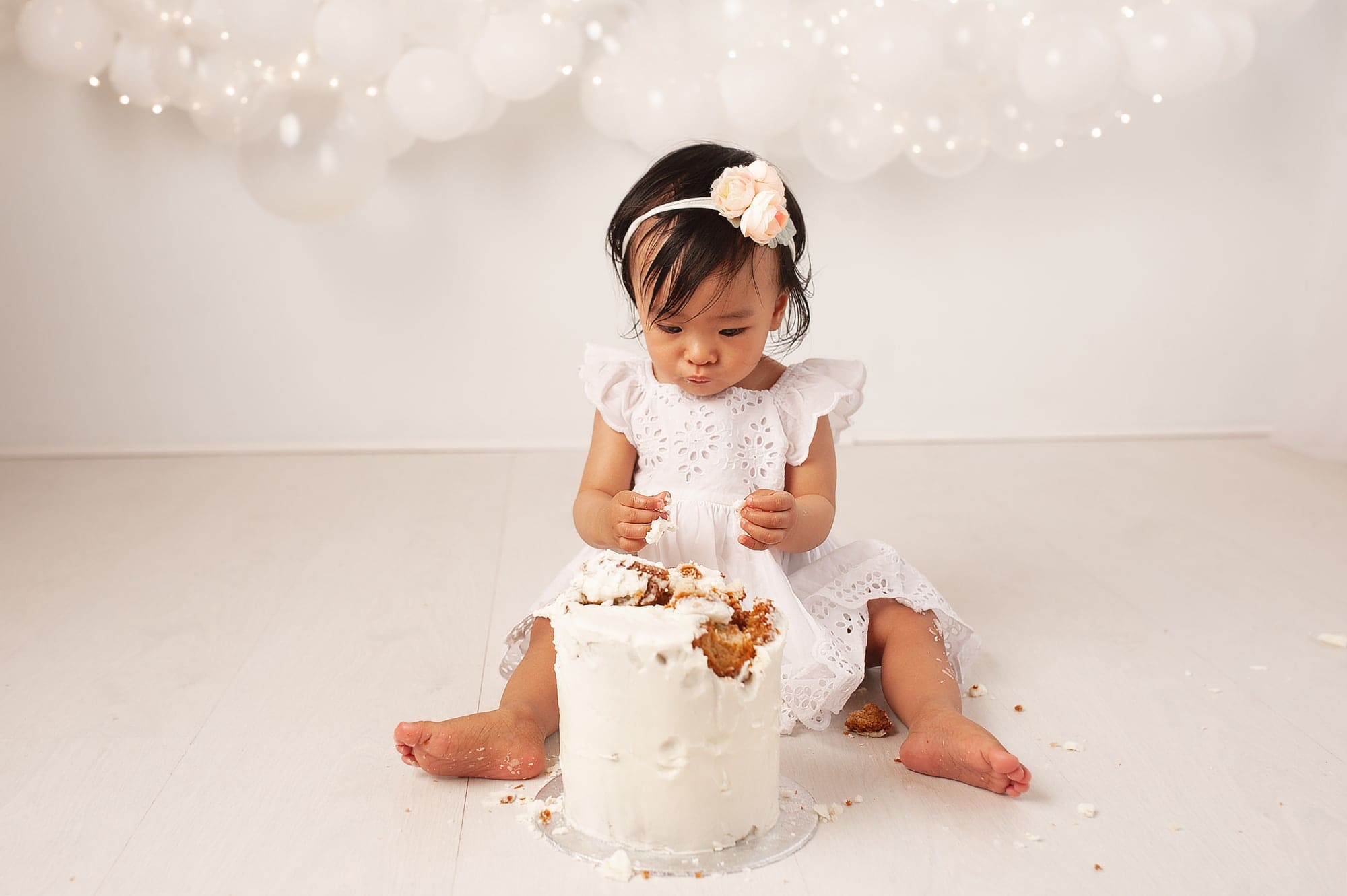 simply white, mini cake smash, balloon garland, fairy lights, white cake, bromley cake smash,