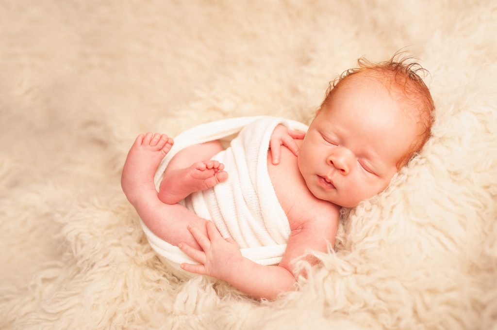 natural baby portrait, baby boy, red head, flokati, white swaddle, newborn photographer bromley, baby pictures