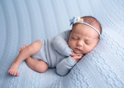 Baby dressed in blue in a newborn baby photography session with Ashleigh Shea Photography