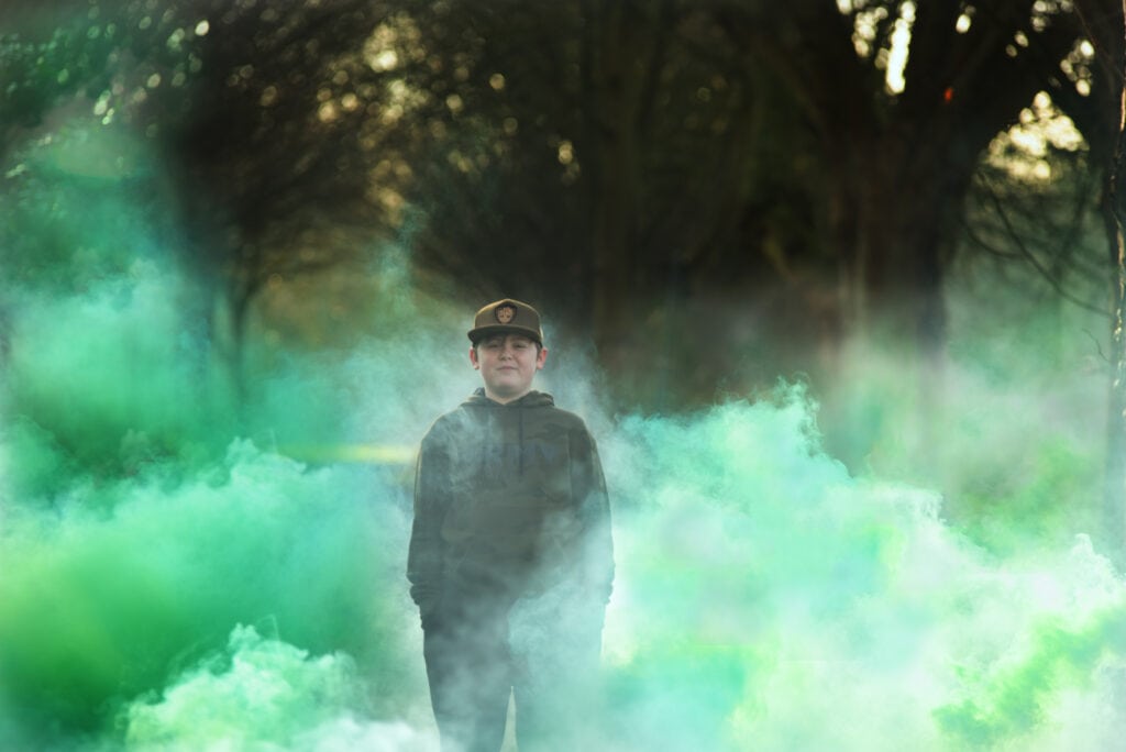 Halloween Photo, Ashleigh Shea Photography, Boy standing in Footscray Meadow woods surrounded by green smoke